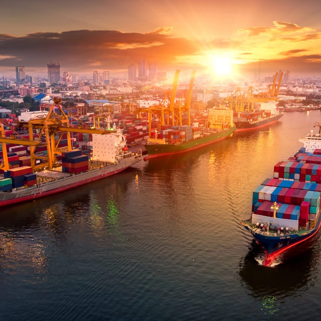 Logistics and transportation of Container Cargo ship and Cargo plane with working crane bridge in shipyard at sunset, logistic import export and transport industry background