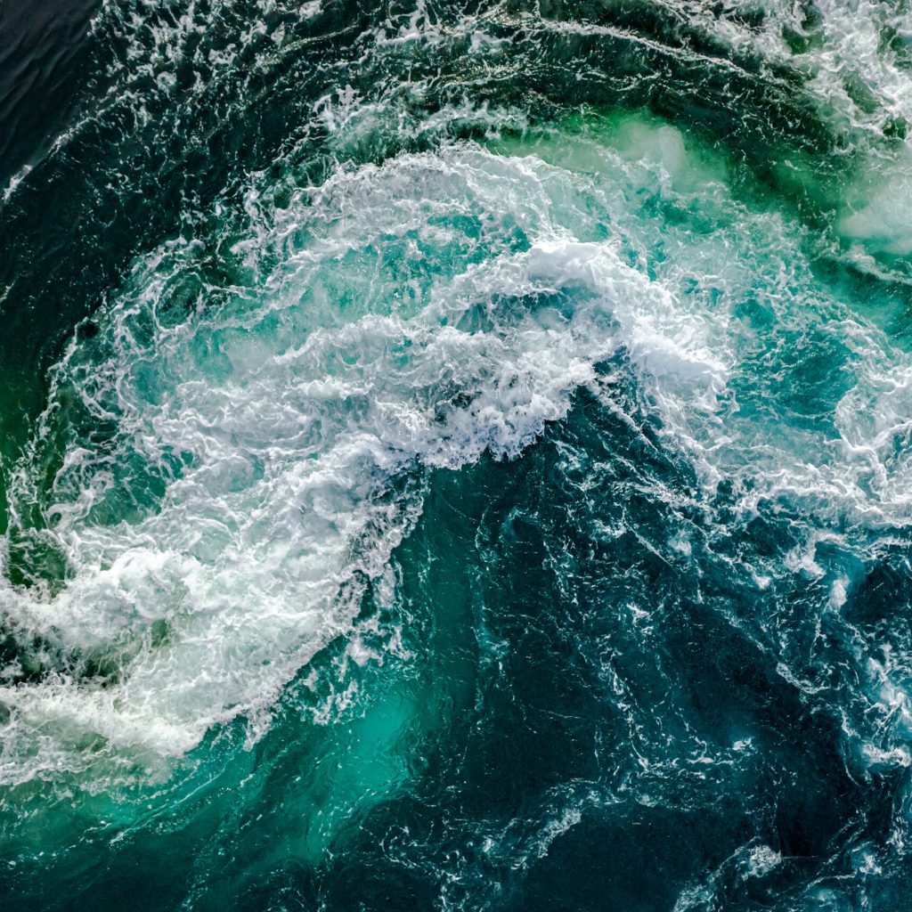 Waves of water of the river and the sea meet each other during high tide and low tide. Whirlpools of the maelstrom of Saltstraumen, Nordland, Norway