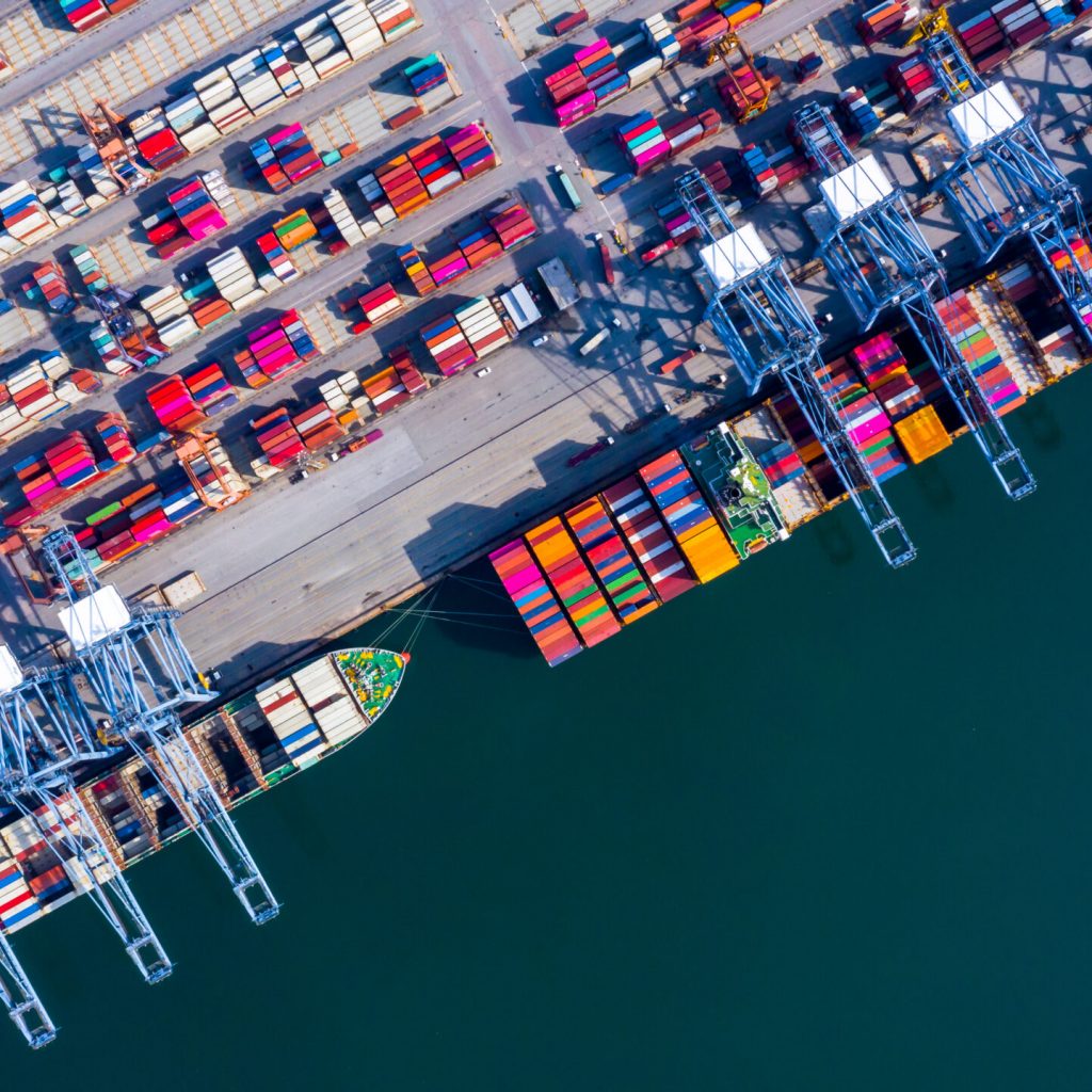Container ship at industrial port in import export global business worldwide logistic and transportation, Container ship unloading freight shipment, Aerial view container cargo vessel boat freight ship.